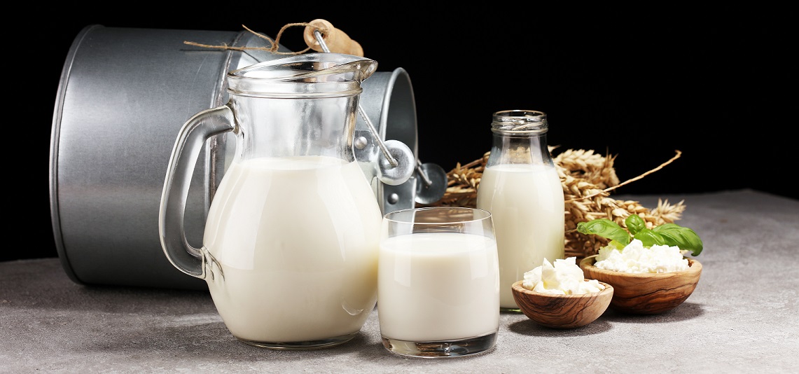 milk products. tasty healthy dairy products on a table. sour cream in a white bowl, cottage cheese bowl, cream in a a bank and milk jar, glass bottle and in a glass